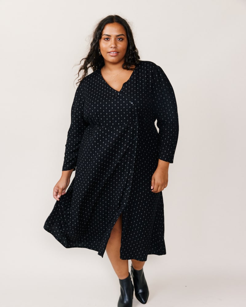 Front of a model wearing a size 1X Lena Wrap Over Dress in Black Diamond Dot by ABLE. | dia_product_style_image_id:271554